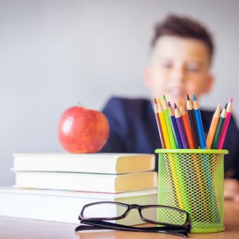 boy looking on a tidied desk